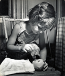 girl feeding doll